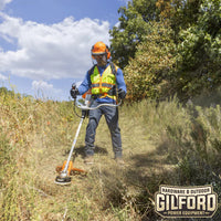 Thumbnail for Worker using the STIHL FS 361 C-EM brush cutter in a rugged field environment, demonstrating its versatility and ergonomic design.