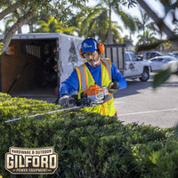 Thumbnail for Close-up of the STIHL HS 87 T hedge trimmer in a residential garden, emphasizing its sharp blades and ergonomic controls for professional results.