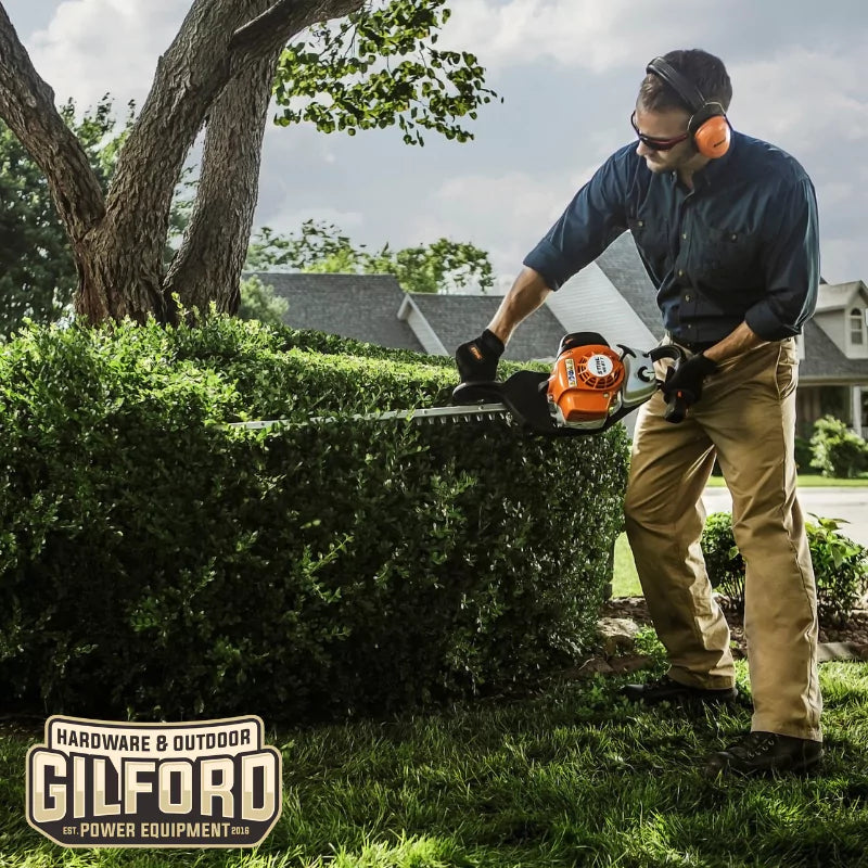 The STIHL HS 87 T hedge trimmer being used on dense shrubbery, showcasing its precision and power for demanding tasks.